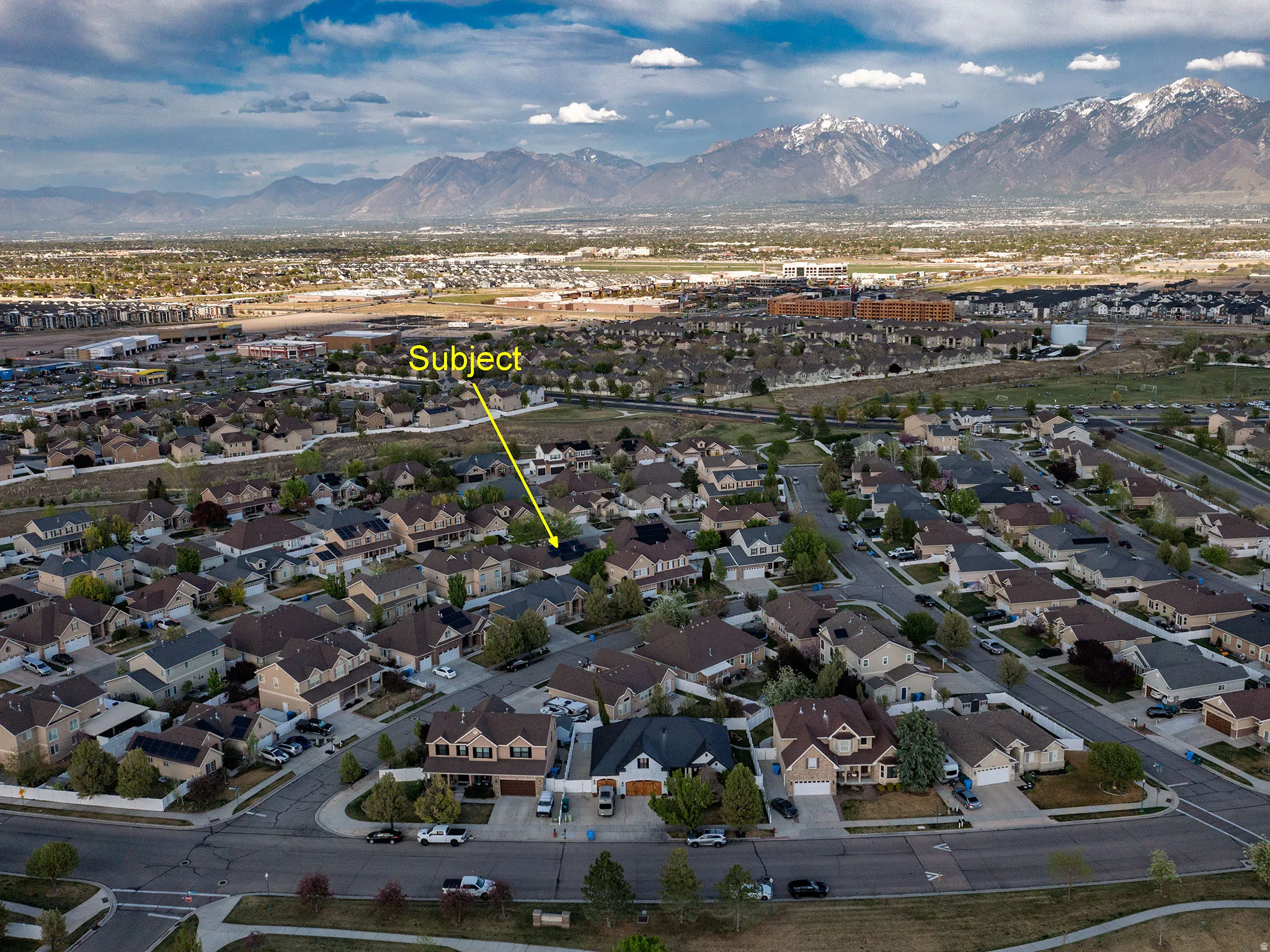 Aerial perspective of suburban area featuring a mountain backdrop