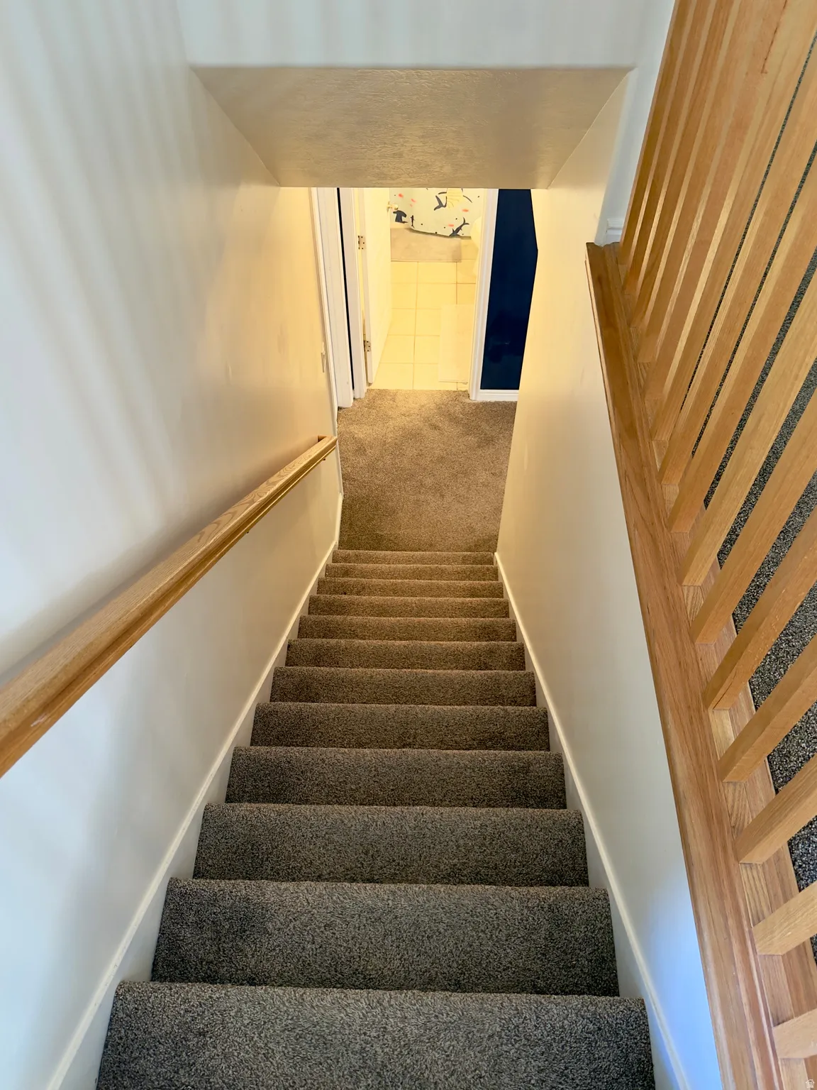 Stairway featuring carpet flooring and baseboards