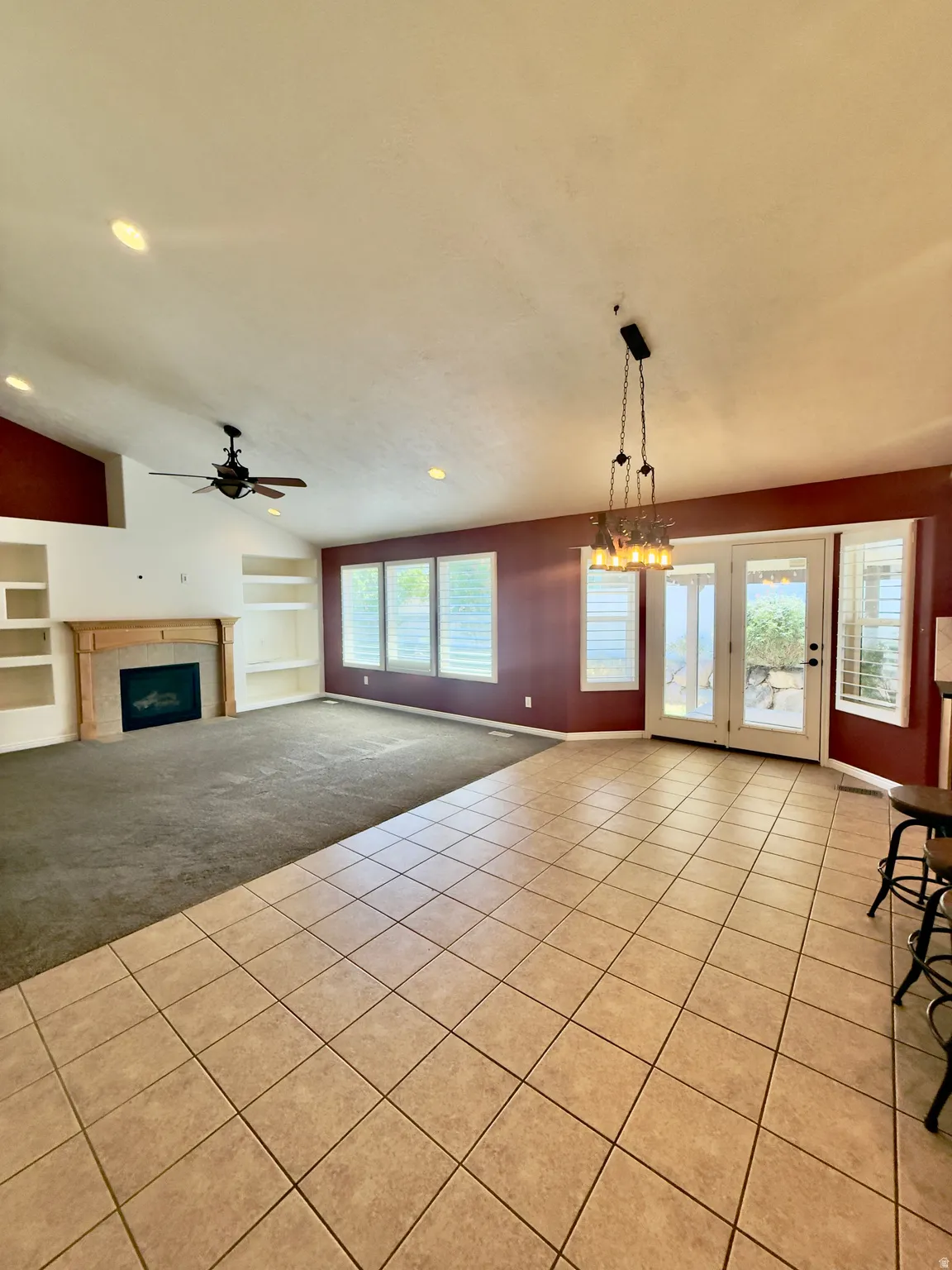 Spacious interior featuring a combination of tile and carpet flooring