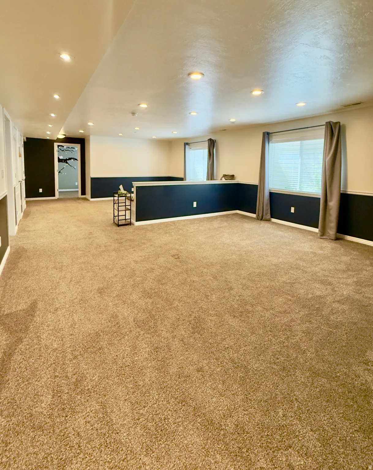 Empty room featuring light carpet and recessed lighting