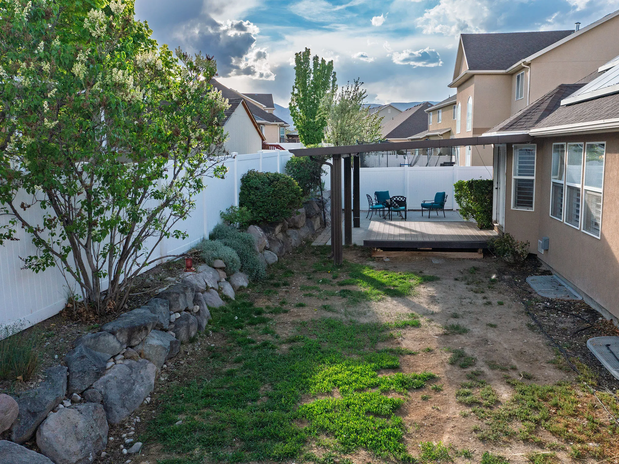 Fenced backyard with a deck