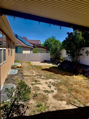 Covered patio area opening to a private backyard