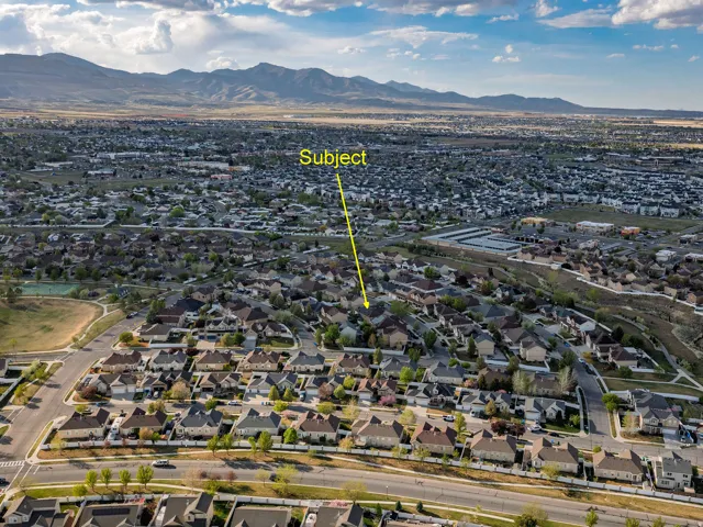 Aerial perspective of suburban area featuring a mountainous background
