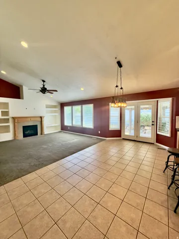 Spacious interior featuring a combination of tile and carpet flooring