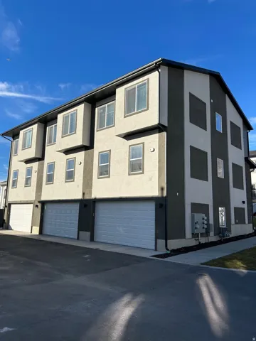 View of apartment building / complex featuring a garage