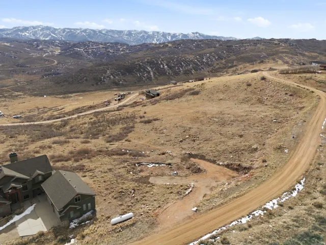 Aerial overview of property's location with a mountain backdrop and rural landscape