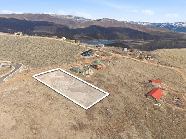 Aerial view of property's location featuring a mountainous background and rural landscape