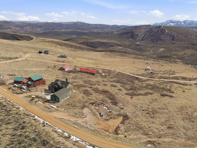Aerial view of property's location featuring rural landscape and a mountainous background