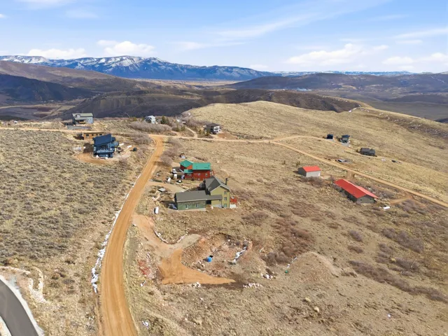 Aerial view of property and surrounding area with mountains and rural landscape