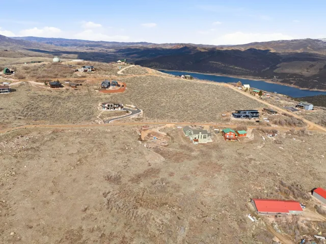 Aerial view of property's location with a water and mountain view