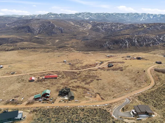 Aerial view of property and surrounding area with mountains and rural landscape