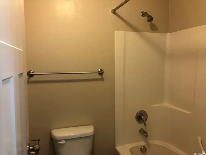 Full bathroom featuring toilet and shower / tub combination