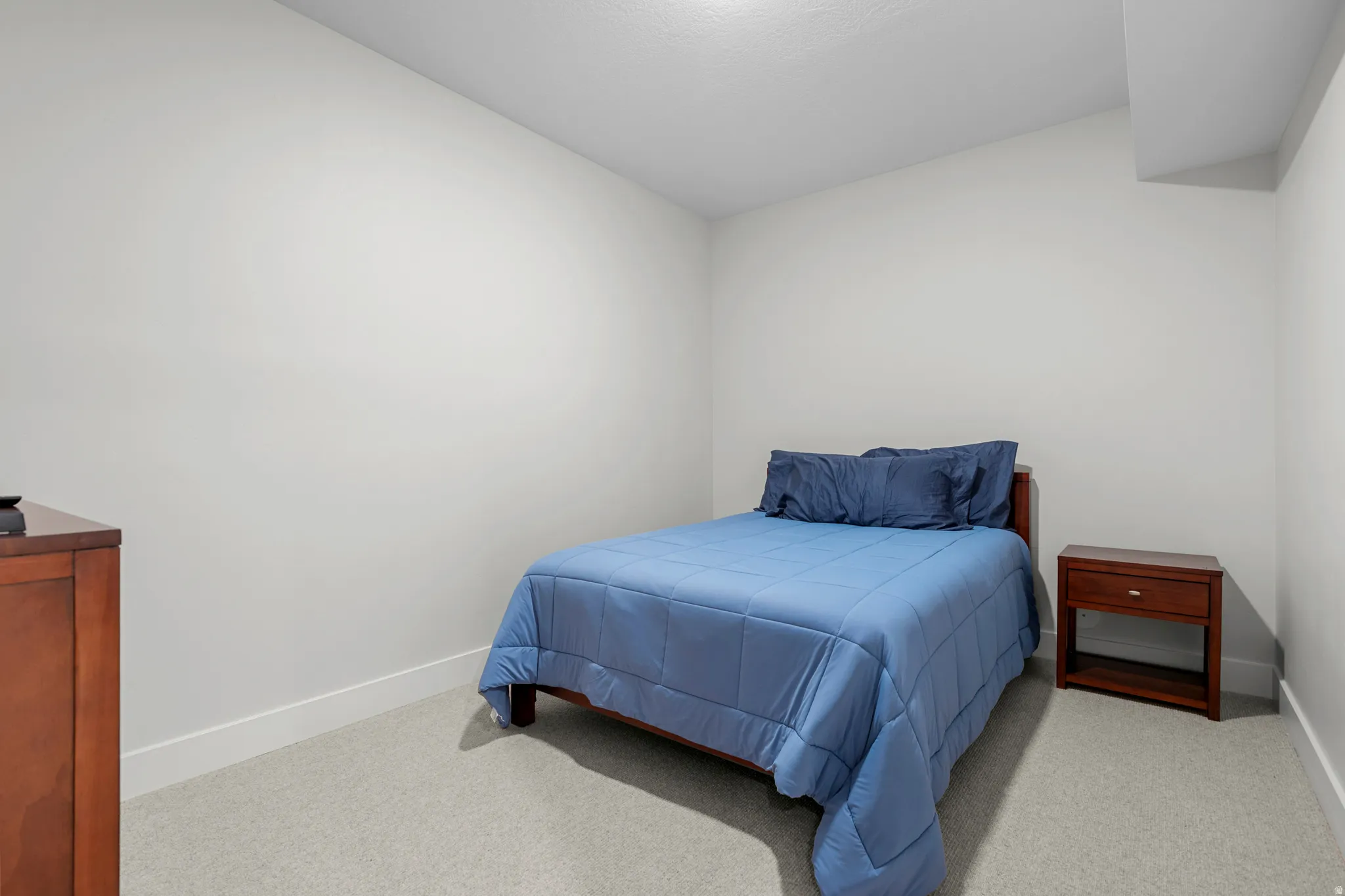 Bedroom featuring light colored carpet