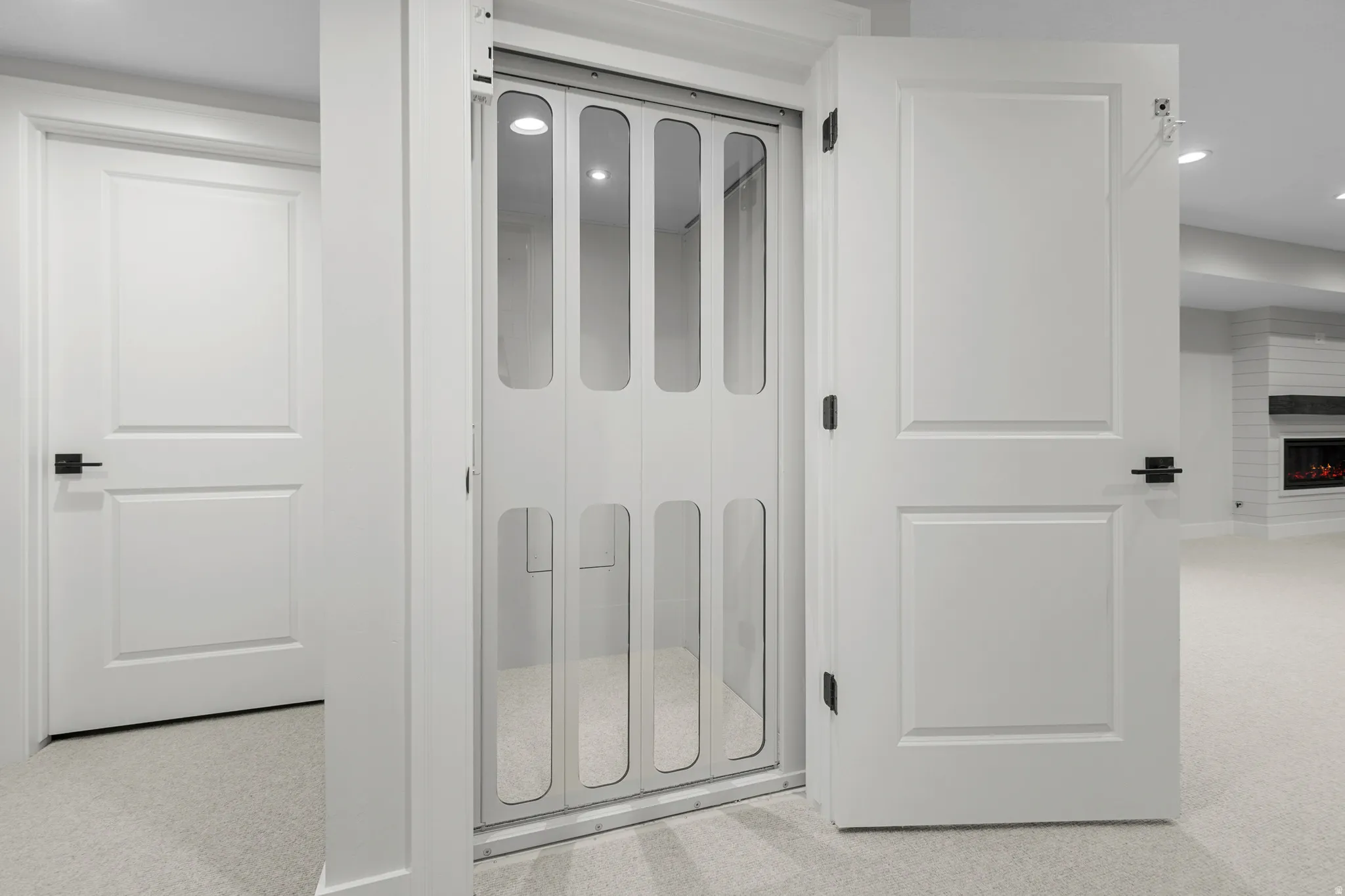 Bathroom featuring recessed lighting, a large fireplace, and light carpet