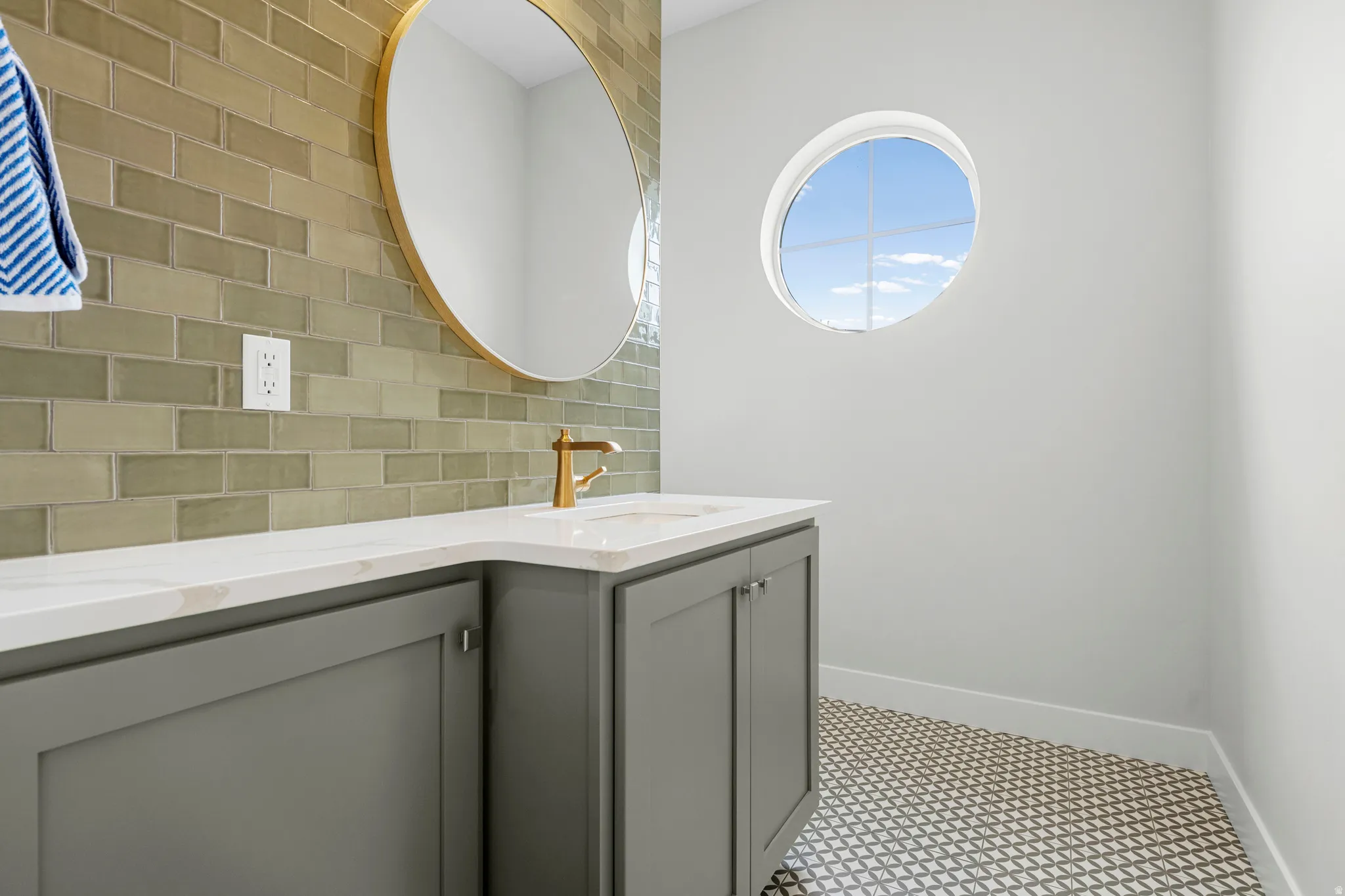 Bathroom featuring decorative backsplash and double vanity