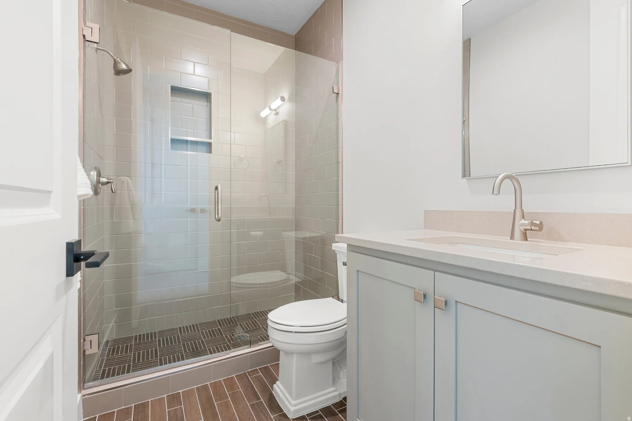 Bathroom featuring vanity and a stall shower
