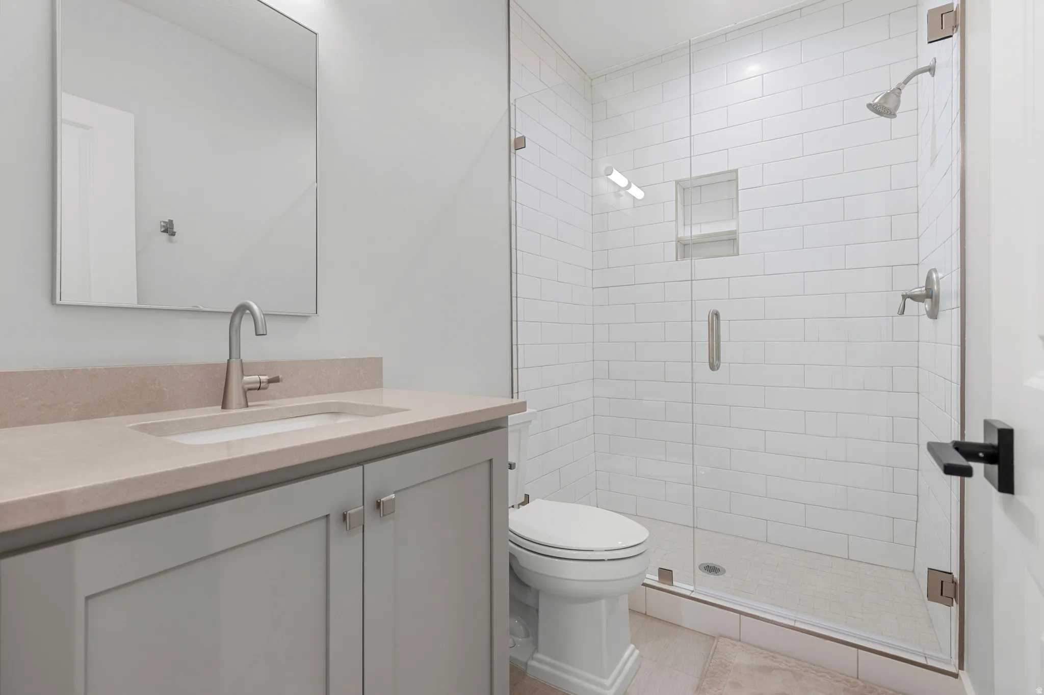 Bathroom with vanity and a shower stall