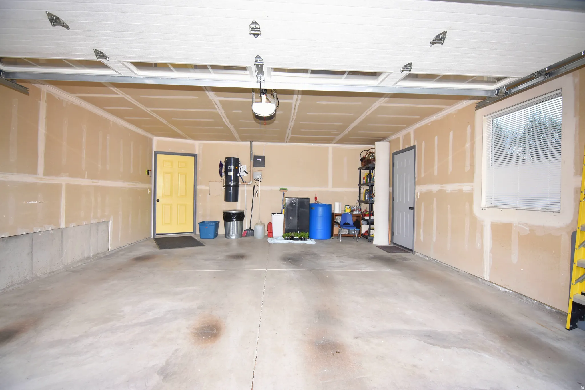 Garage featuring a central vacuum unit and a garage door opener