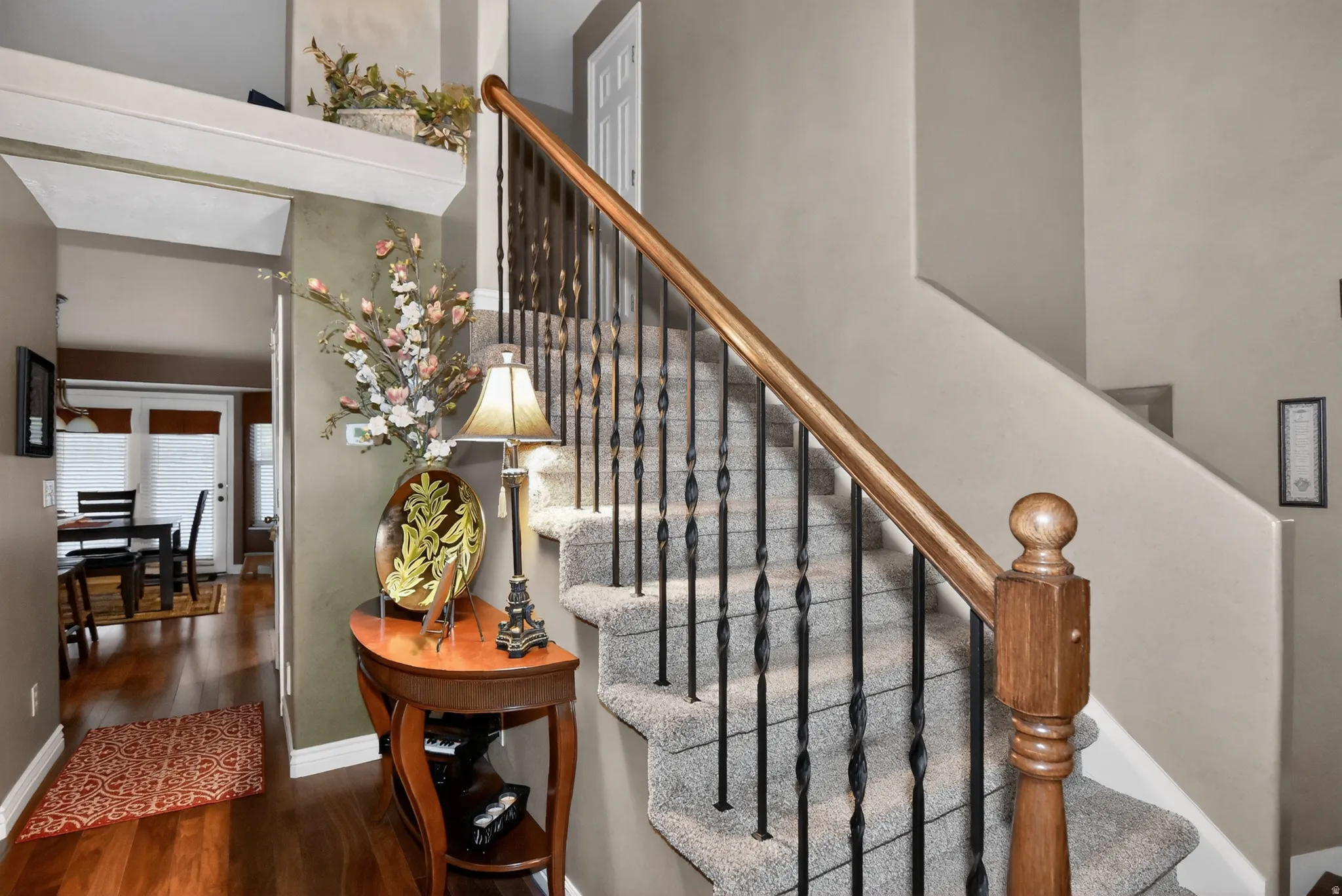 Staircase featuring wood finished floors and baseboards
