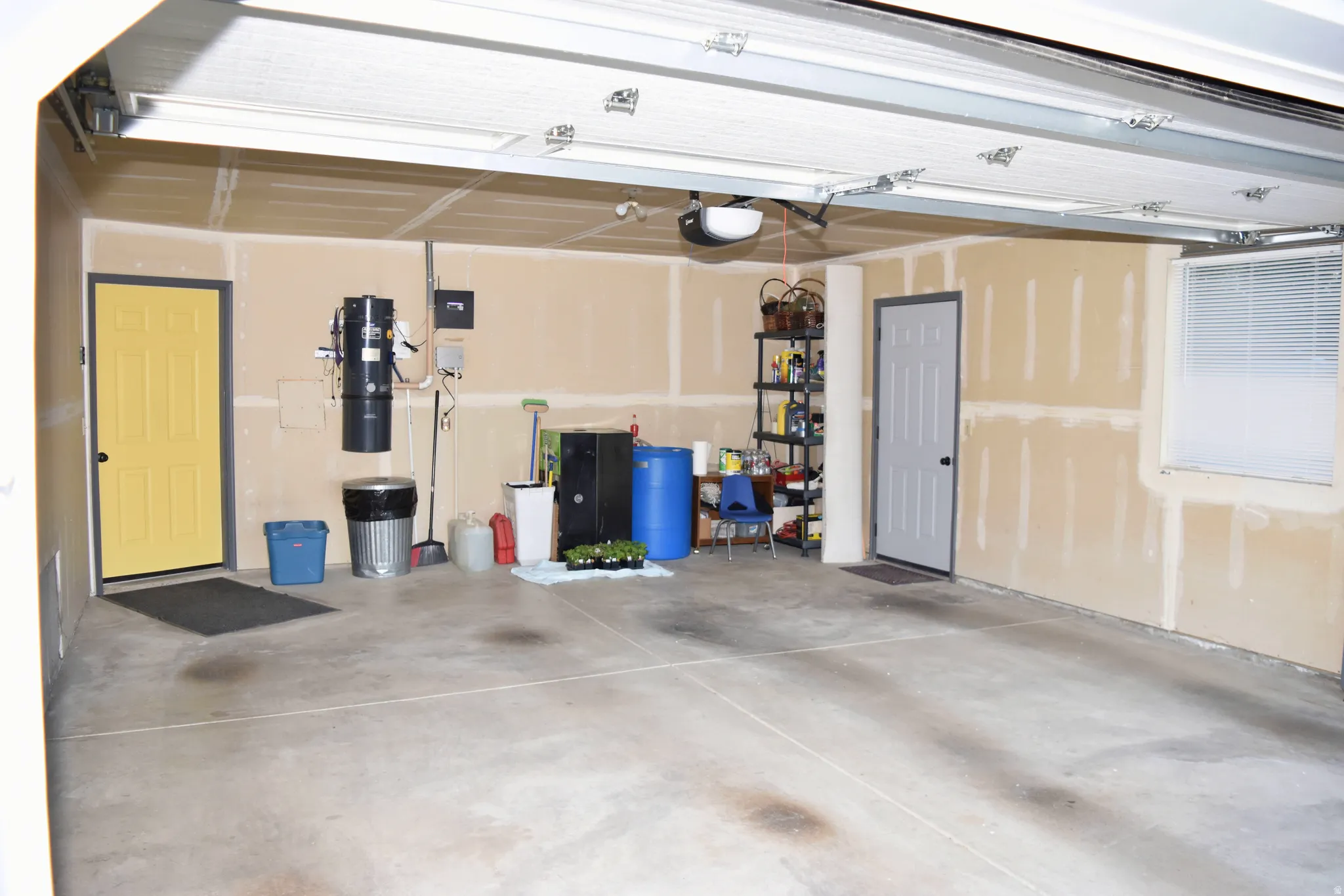 Garage with a central vacuum unit and a garage door opener