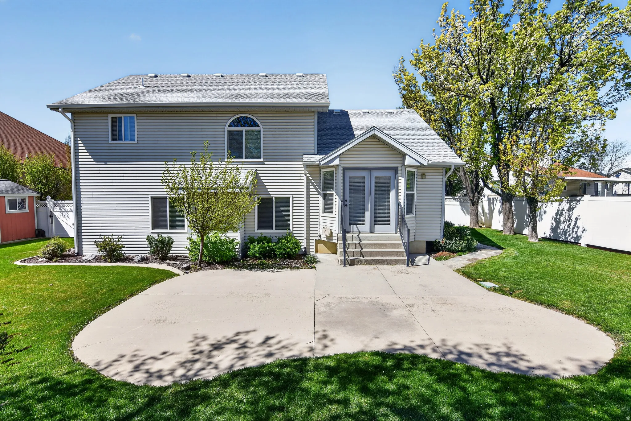 View of front of property featuring roof with shingles, entry steps, and a patio