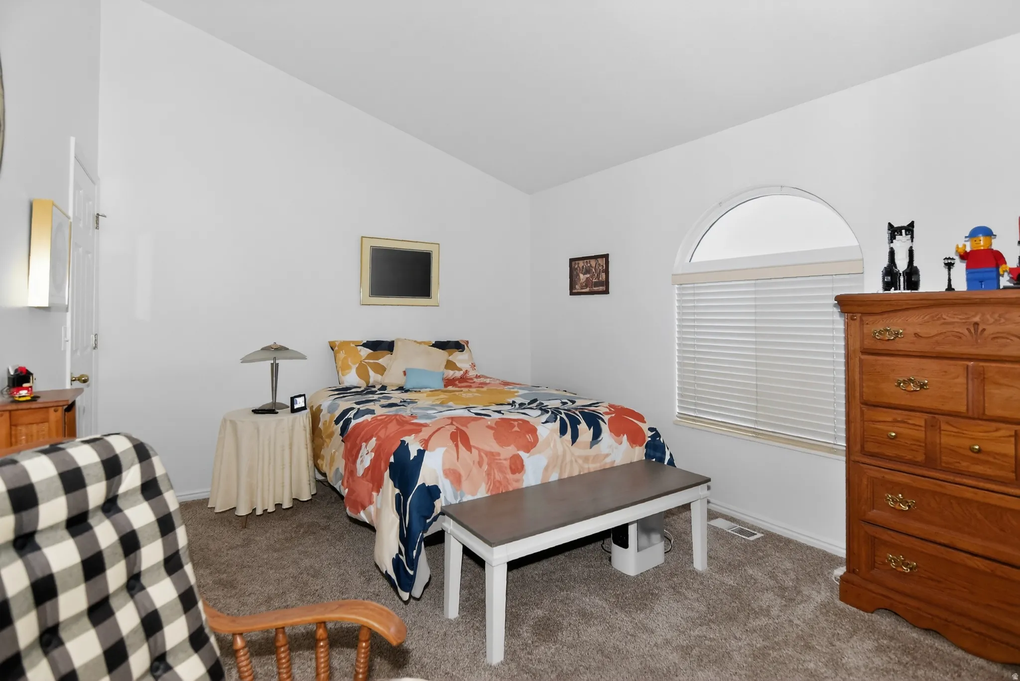Bedroom featuring lofted ceiling and carpet
