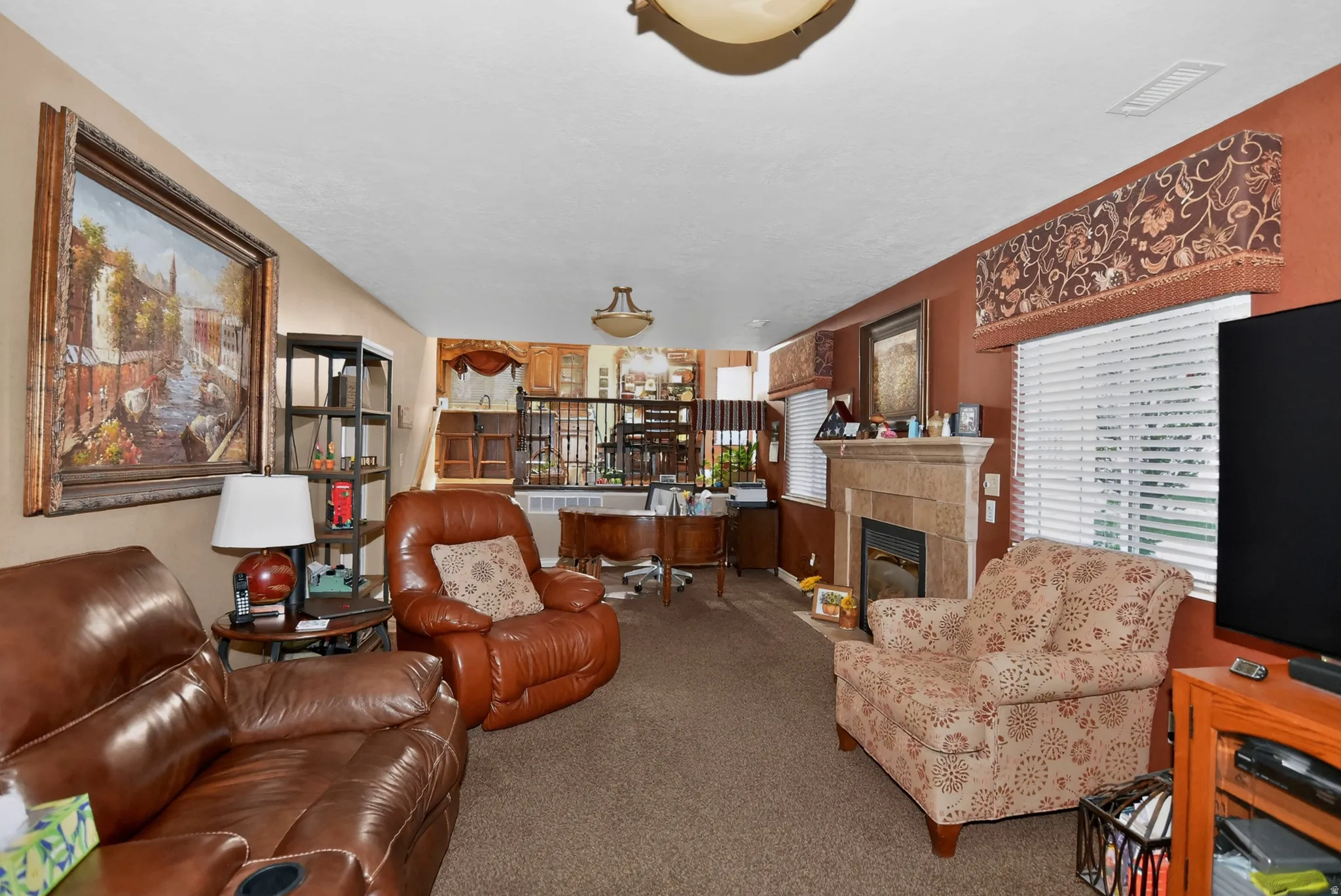 Carpeted living room with a fireplace