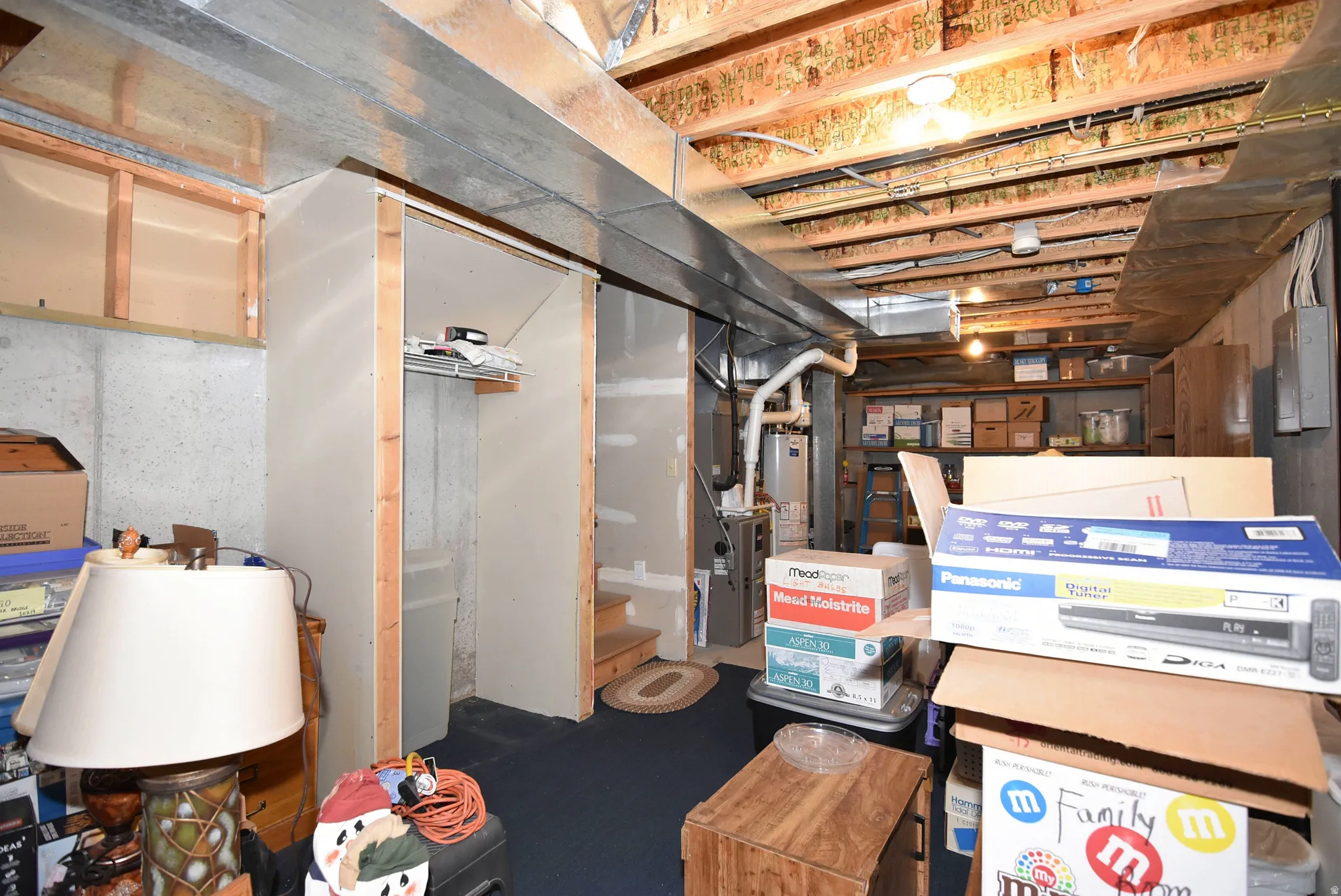 Unfinished basement featuring gas water heater
