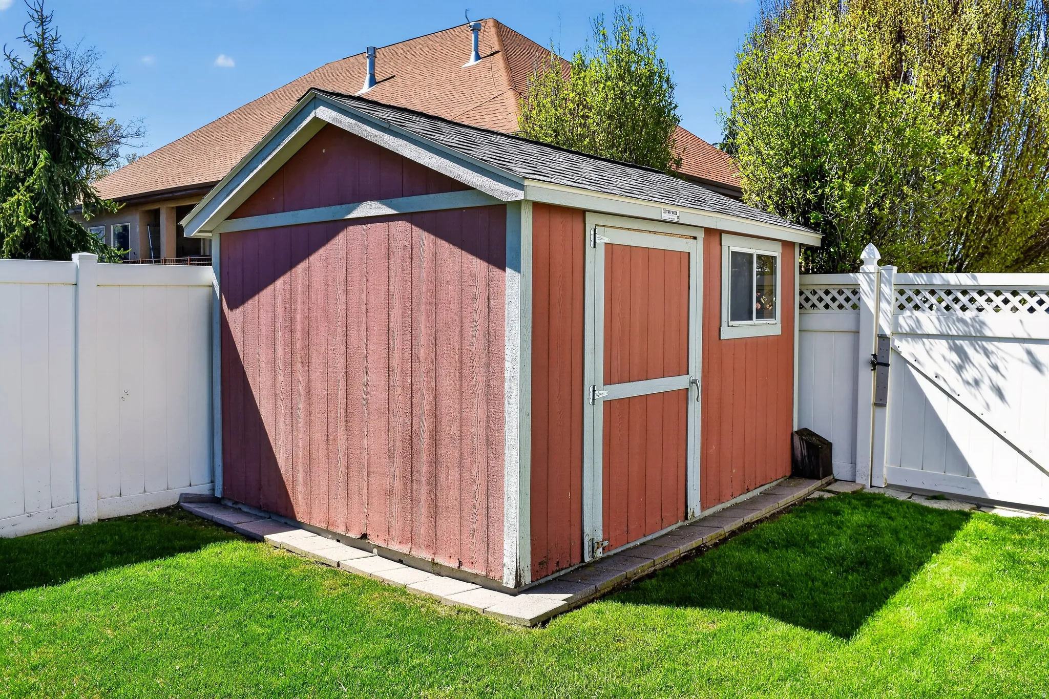 View of shed featuring a gate and a fenced backyard