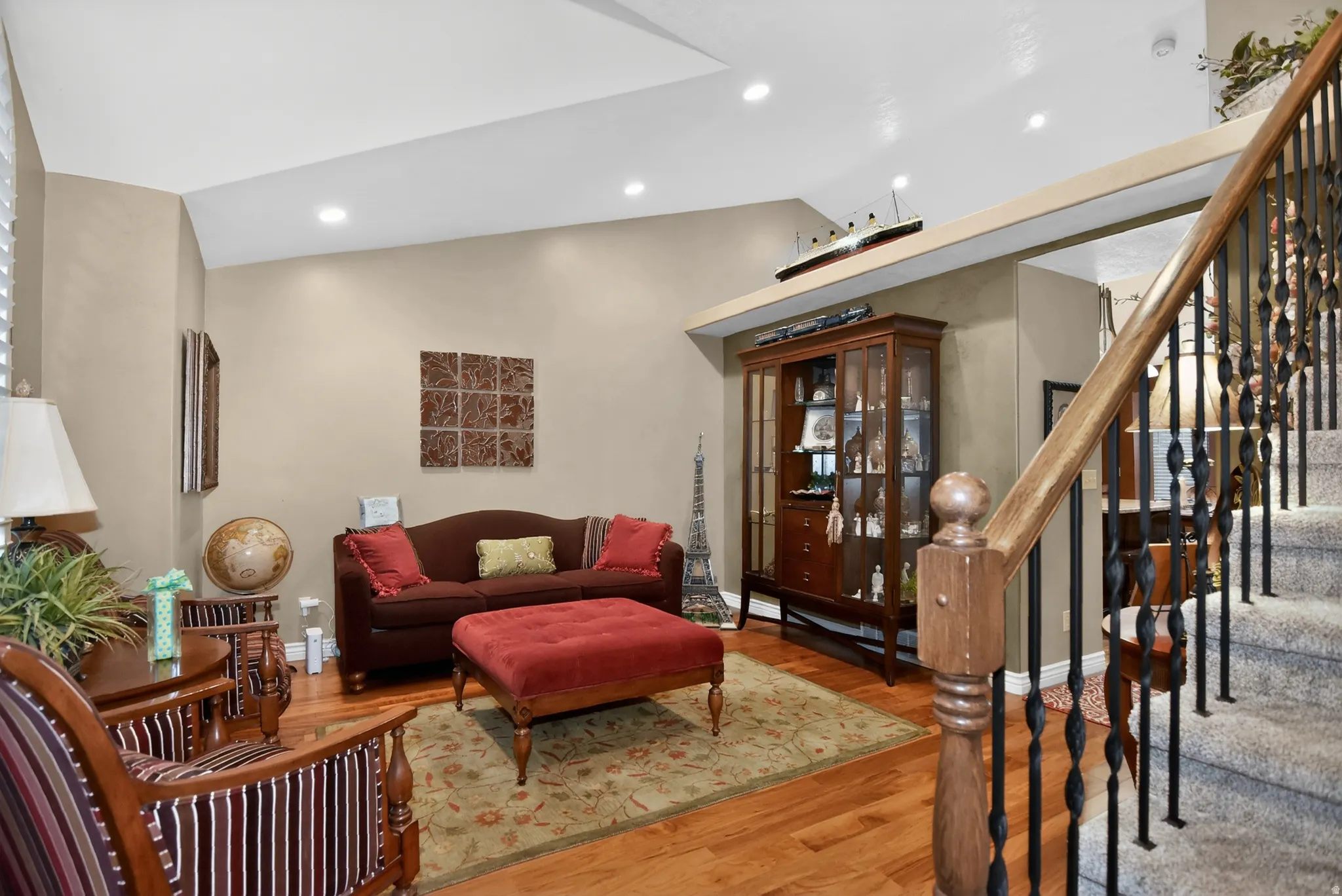 Living area featuring wood finished floors, lofted ceiling, and recessed lighting