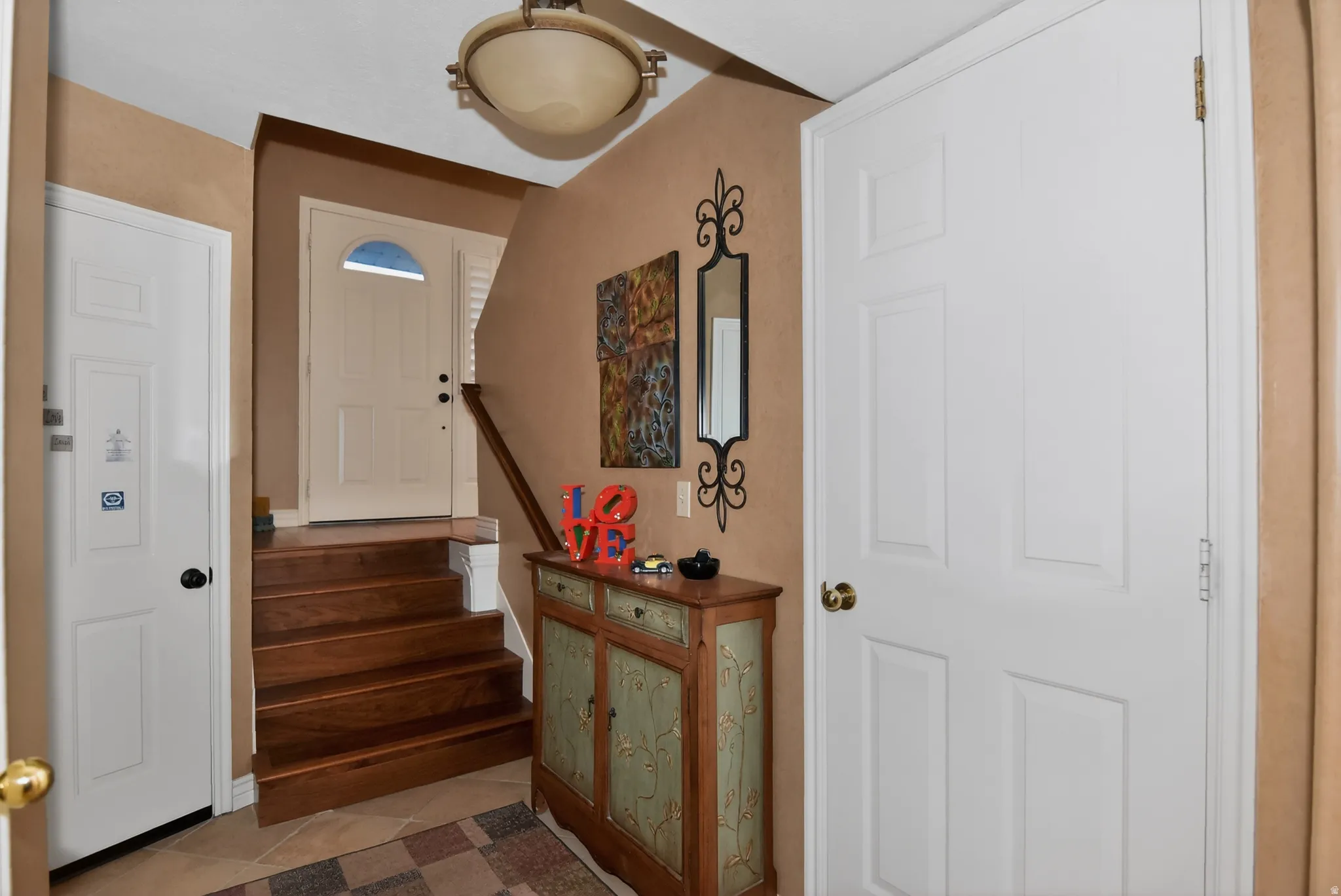 Entryway with stairway and tile patterned floors