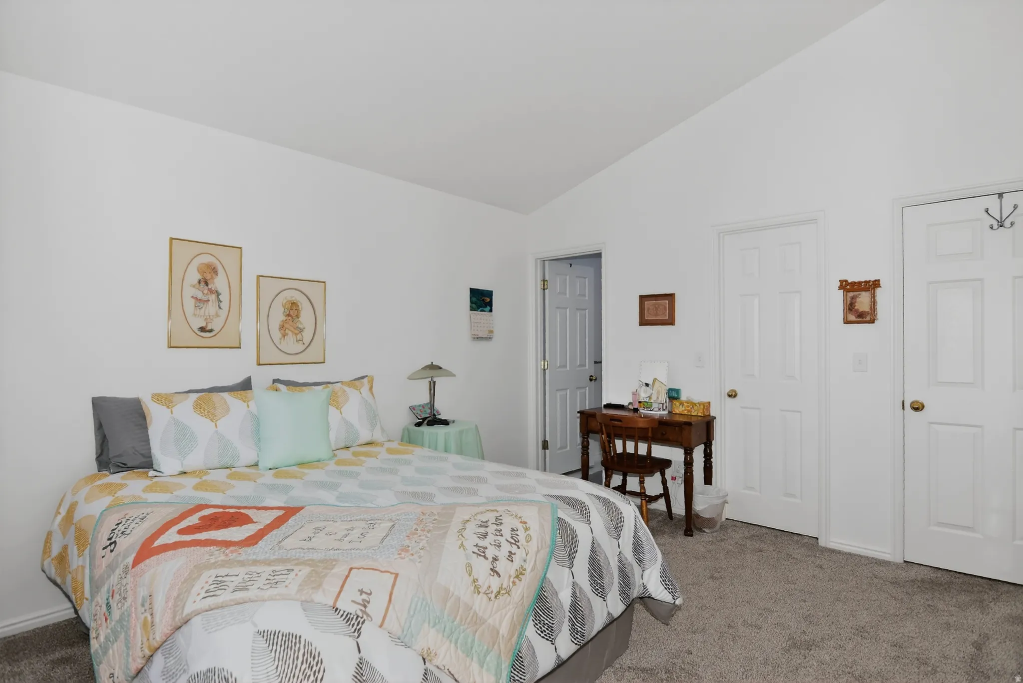 Bedroom featuring carpet and vaulted ceiling