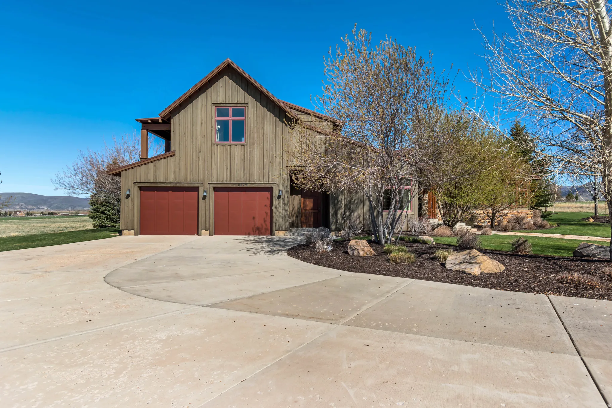 View of front of property featuring concrete driveway, a garage, and a mountain view