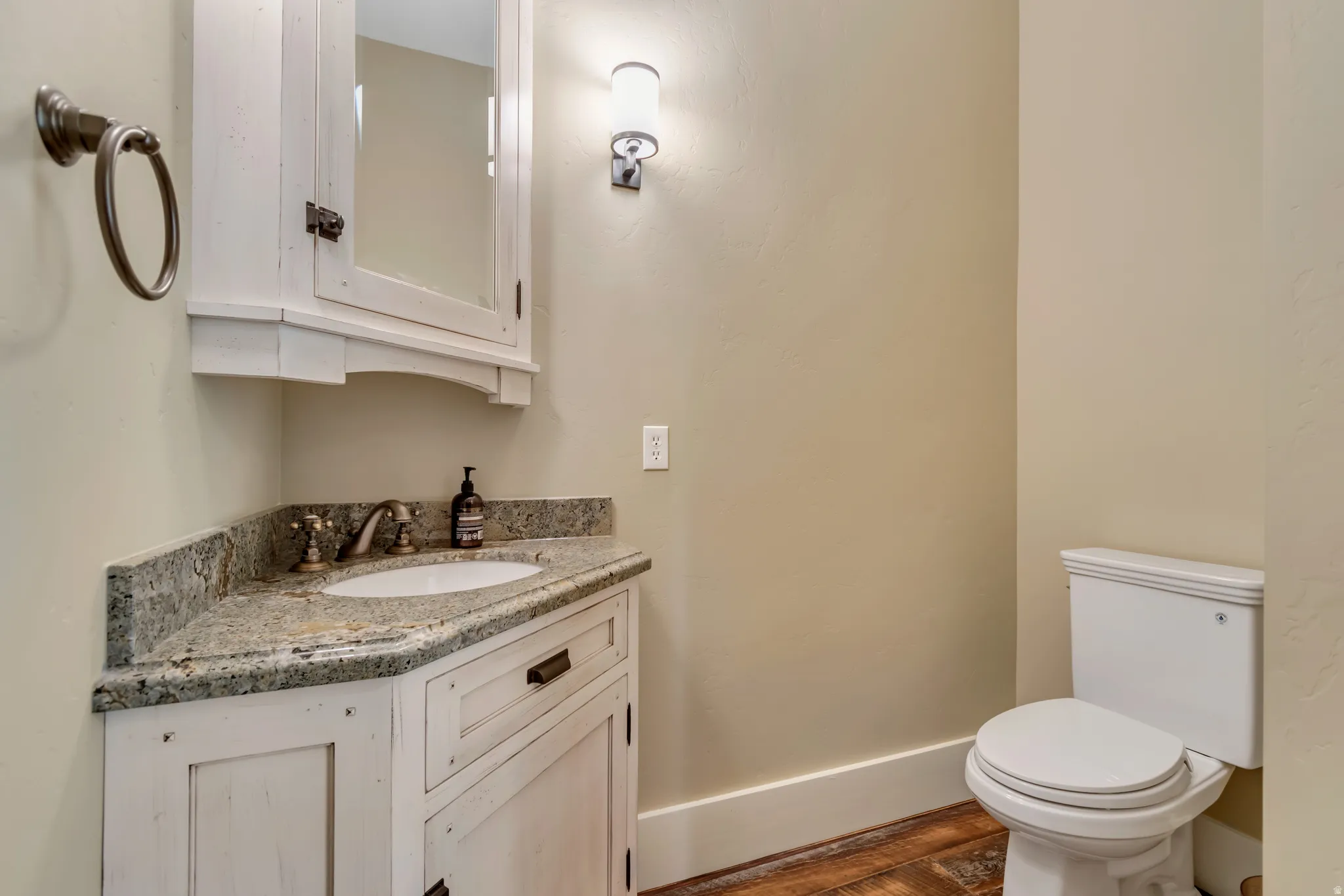 Bathroom with vanity and dark wood-type flooring