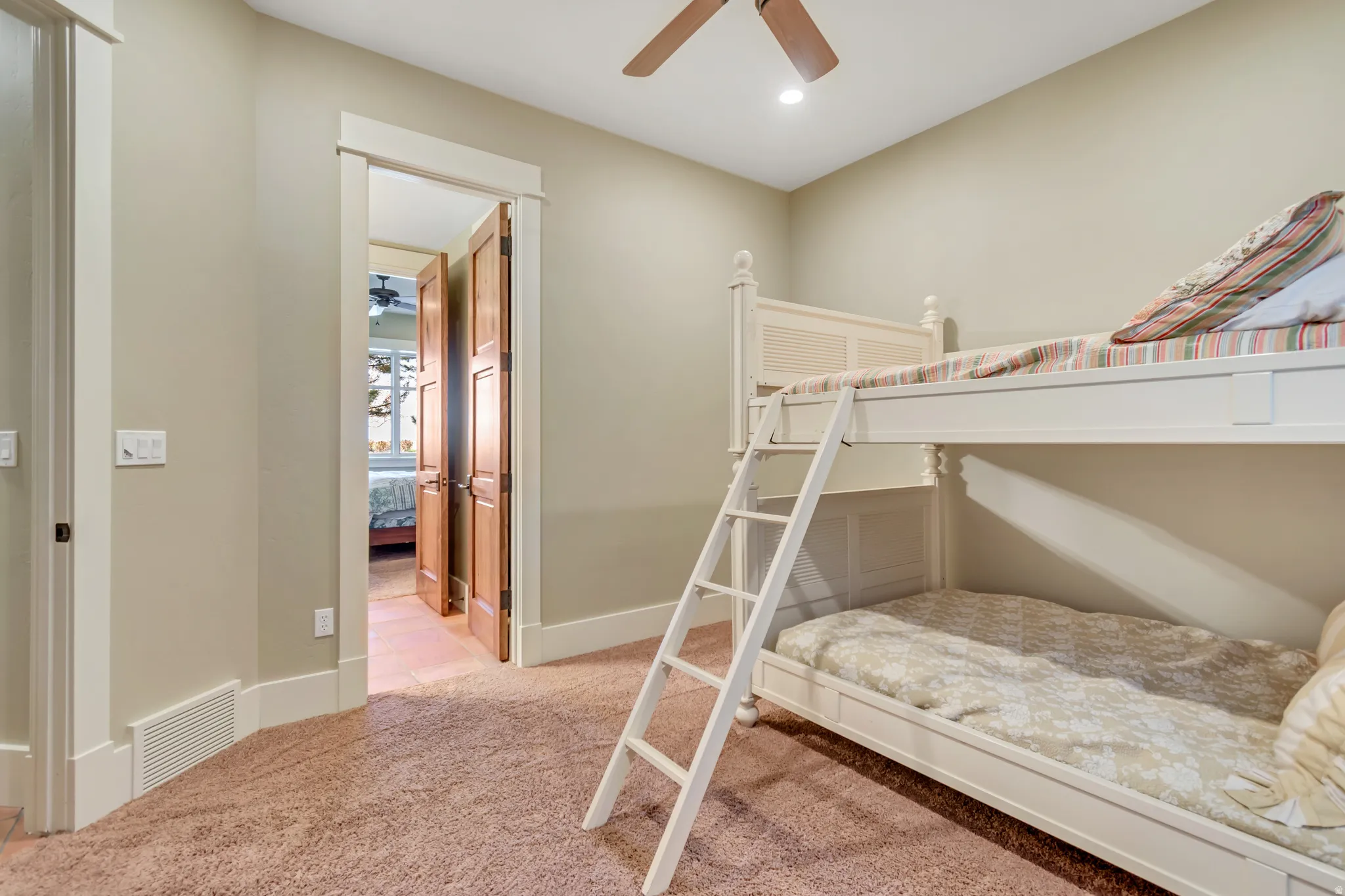 Bedroom with light colored carpet, a ceiling fan, and recessed lighting
