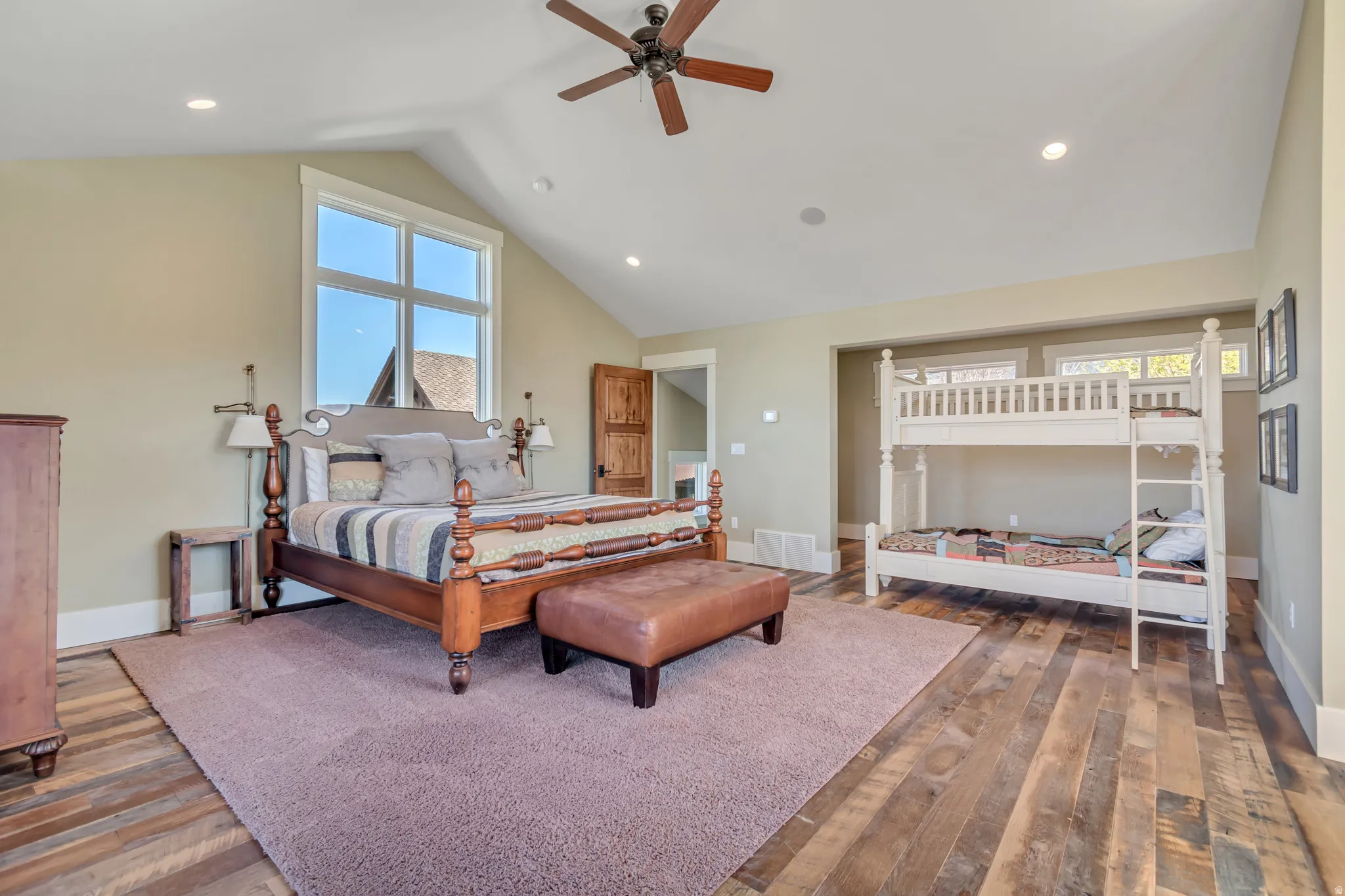 Bedroom with a ceiling fan, dark wood-style flooring, a high ceiling, and recessed lighting