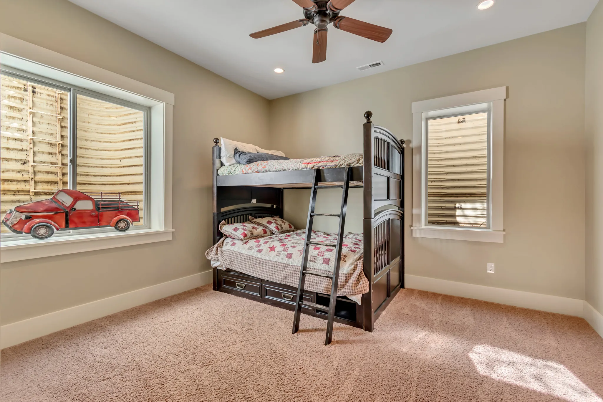 Bedroom featuring light colored carpet, a ceiling fan, and recessed lighting
