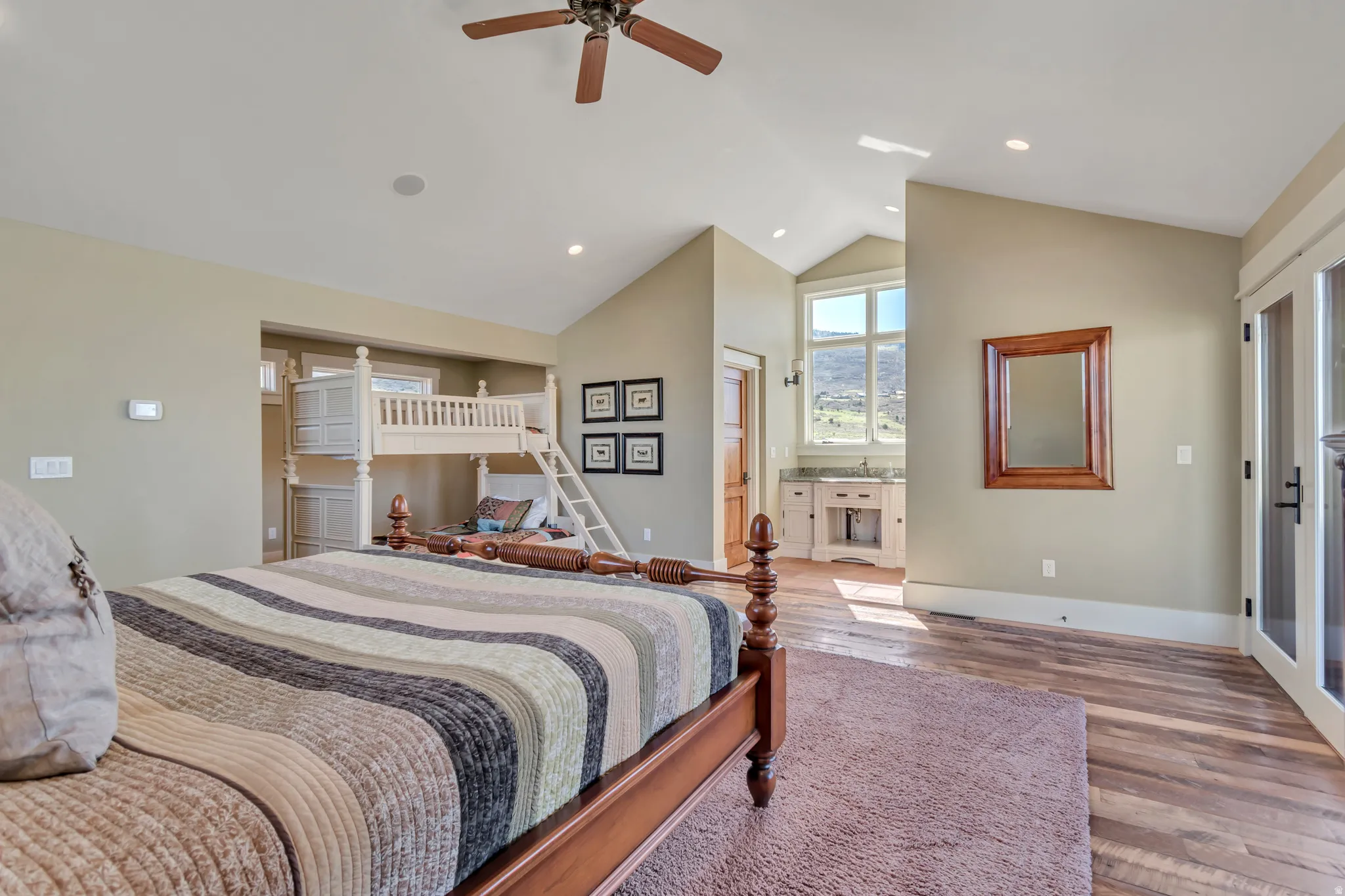 Bedroom featuring wood finished floors, access to exterior, ceiling fan, recessed lighting, and lofted ceiling