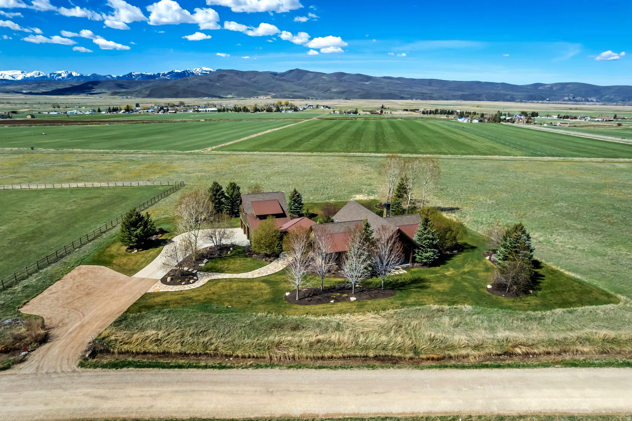 Aerial view of sparsely populated area with agricultural land and a mountain backdrop