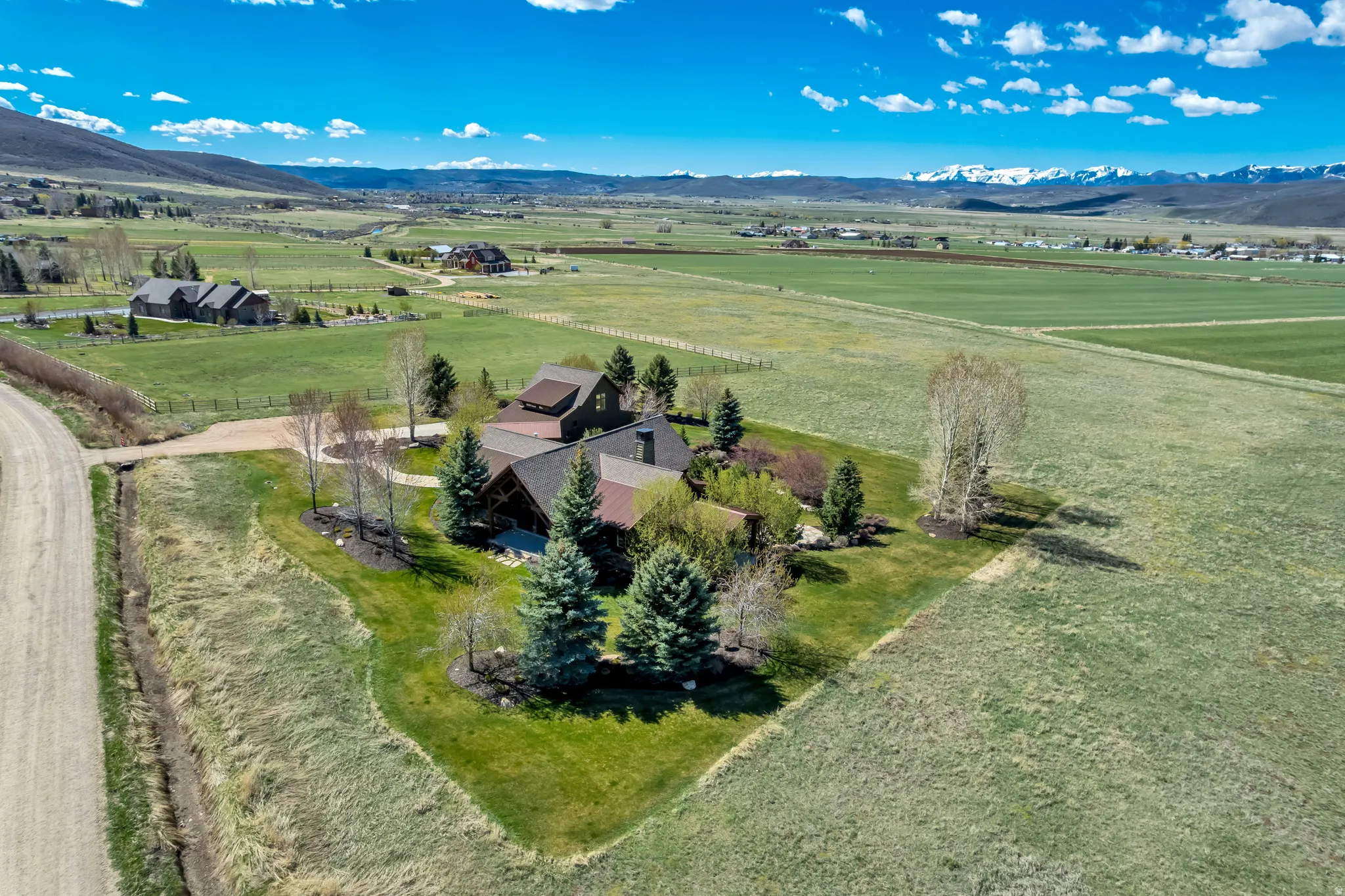 Aerial view of sparsely populated area with a mountain backdrop and agricultural land
