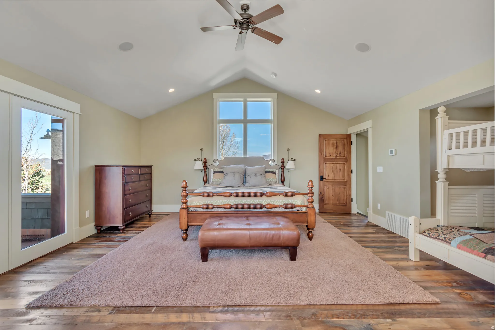 Bedroom with access to outside, wood finished floors, and a ceiling fan