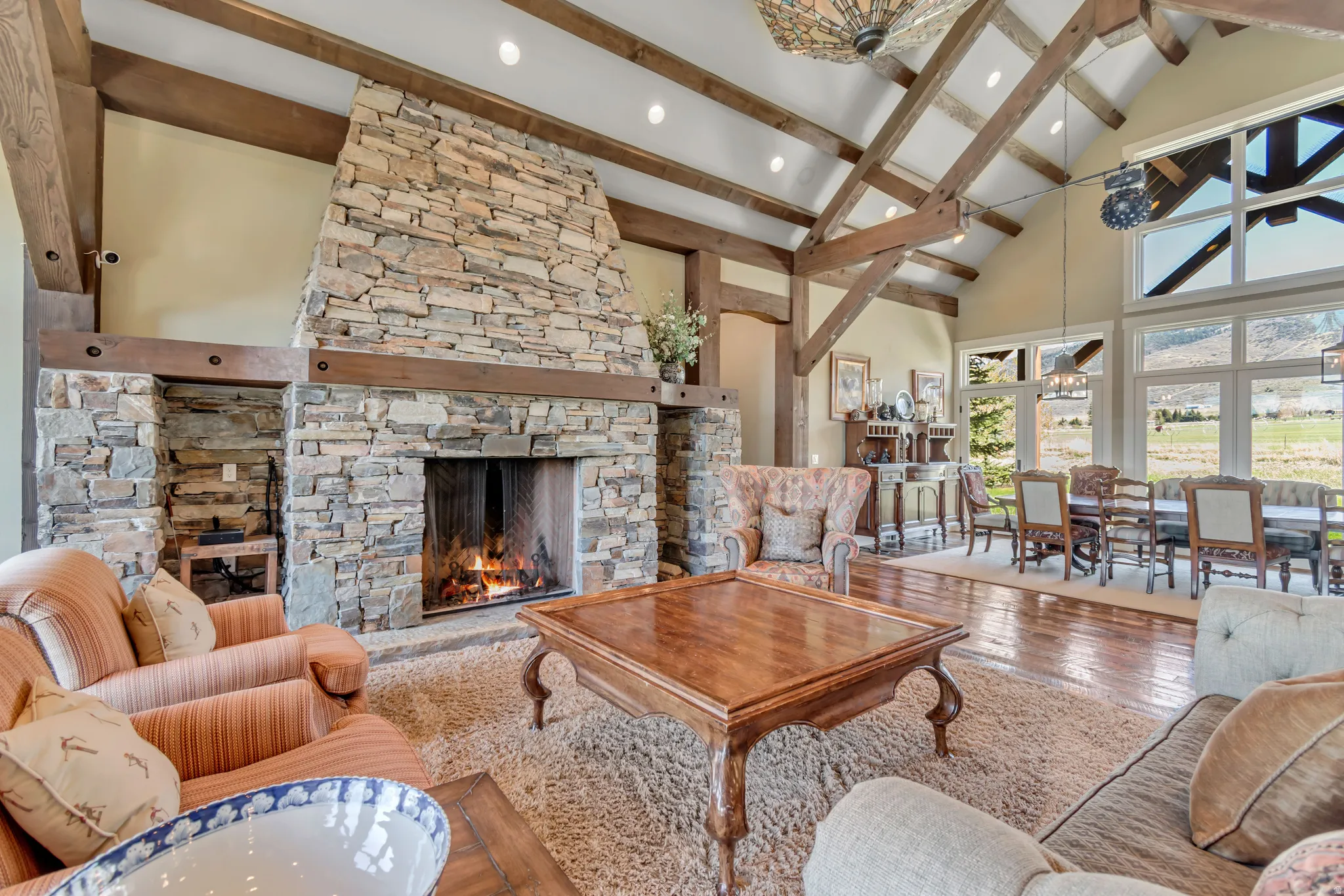 Living room featuring hardwood / wood-style floors, a fireplace, vaulted ceiling, and recessed lighting