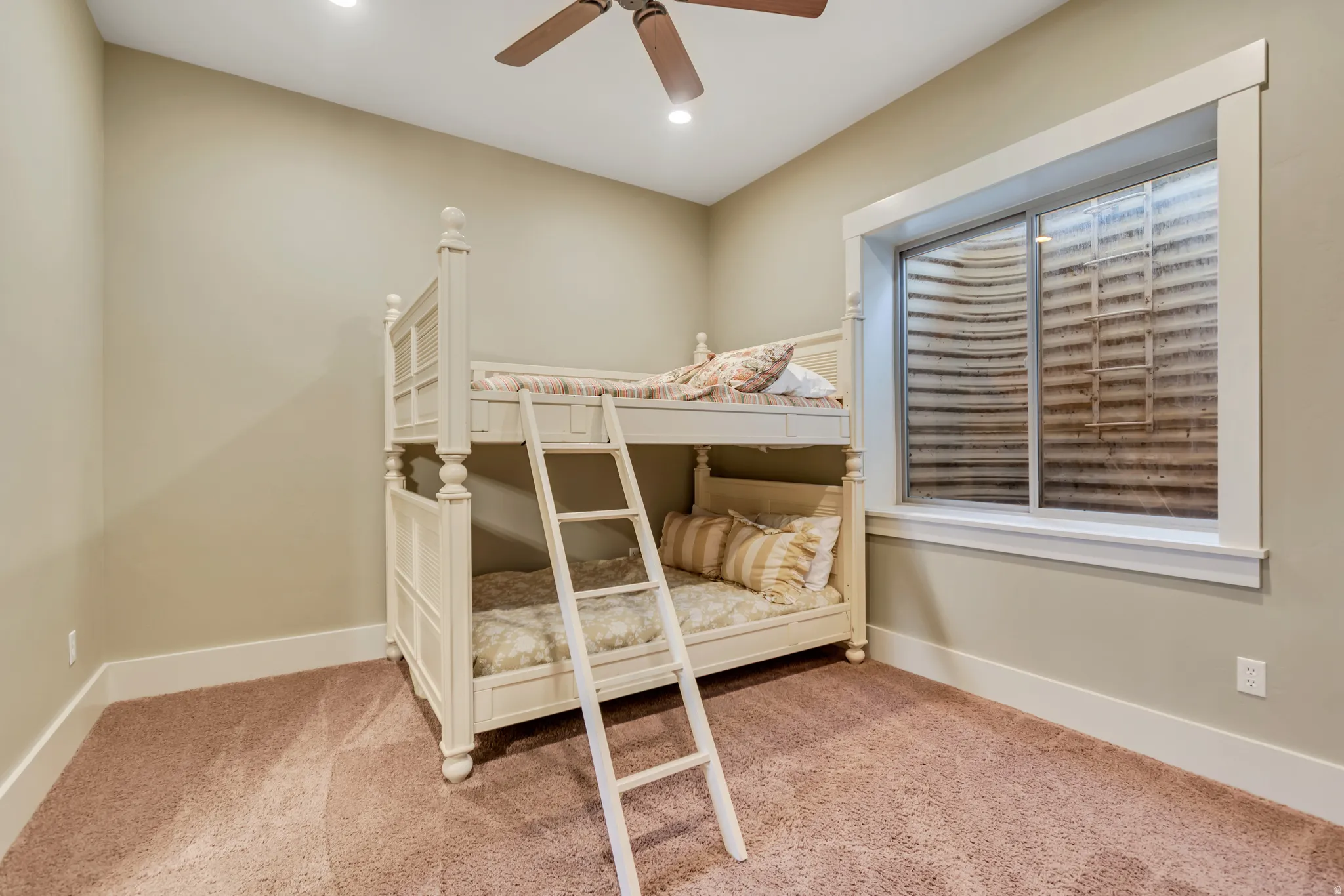 Bedroom with light colored carpet, ceiling fan, and recessed lighting