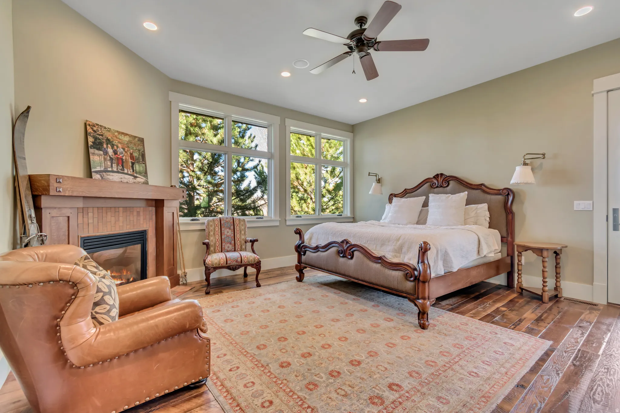 Bedroom with a fireplace, wood-type flooring, recessed lighting, and a ceiling fan