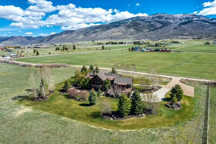 Aerial view of sparsely populated area with a pastoral area and a mountainous background