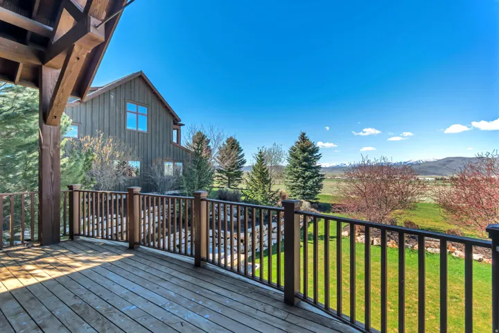 Wooden terrace with a lawn and a mountain view