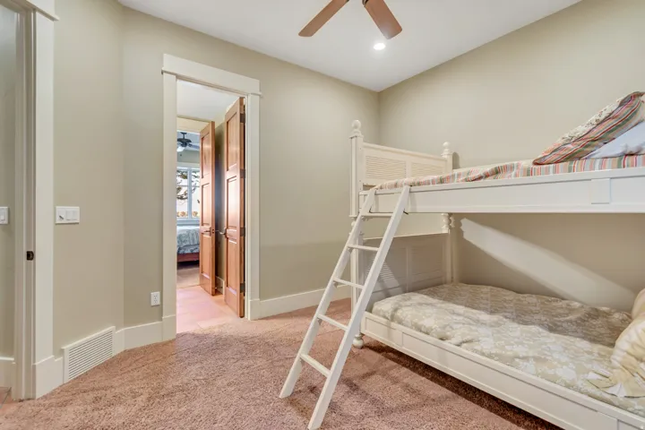 Bedroom with light colored carpet, a ceiling fan, and recessed lighting