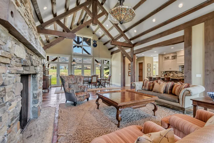 Living area featuring a fireplace, vaulted ceiling, recessed lighting, and wood finished floors