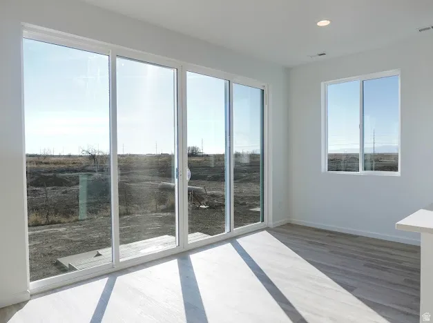 Unfurnished room featuring light wood-style flooring and recessed lighting