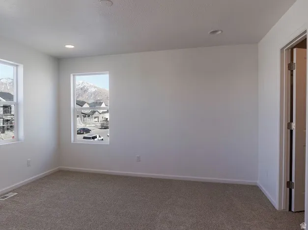 Empty room featuring carpet and recessed lighting